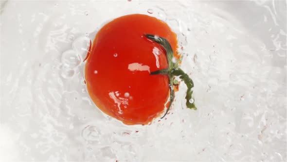 Red Tomato Falling and Plunging in Water