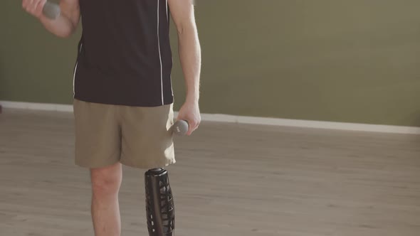 Man with Prosthetic Leg Exercising with Dumbbells