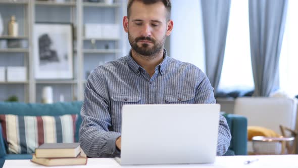 Man Leaving Workplace after Completing Work on Laptop