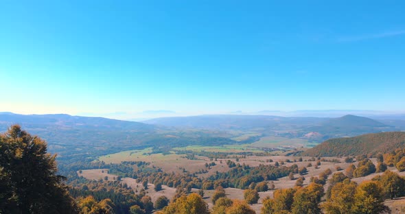 Fly Over Mountains And Hills With Autumnal Vegetations On A Misty Morning. Aerial Drone