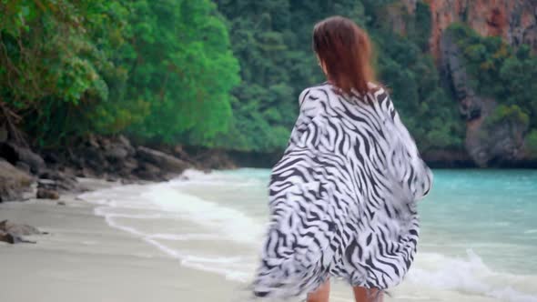 Woman Running on the Beach and Turns Back To the Camera She Running Against Amazing Tropical Lagoon