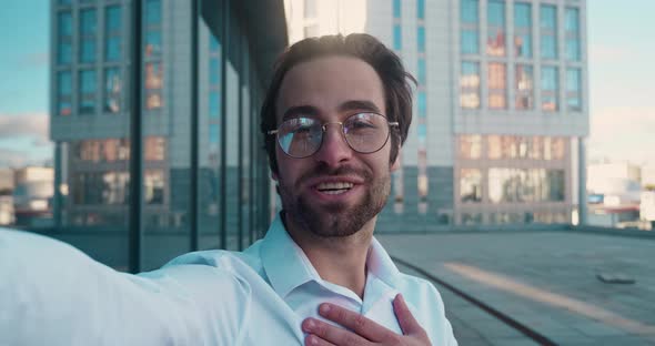 Shot of Businessman with Glasses Making Video Call Standing Outdoors in City