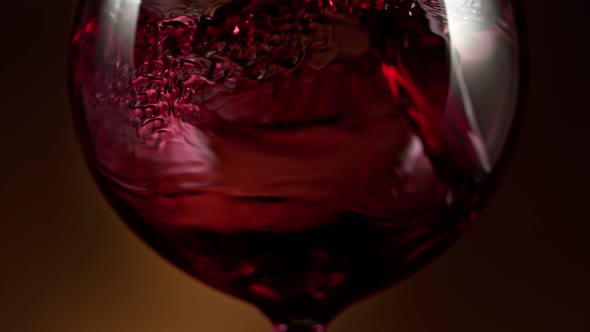 Super Slow Motion Detail Shot of Pouring Red Wine on Luxury Gradient Background at 1000Fps