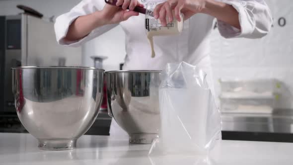 Pastry Chef Pours the Mousse Into a Pastry Bag