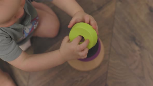 Unrecognizable Caucasian Child Baby Playing Toy Wooden Pyramid Early Education