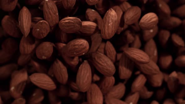 Super Slow Motion Shot of Almonds Flies After Being Exploded Against Black Background 1000Fps