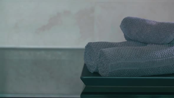 View of Woman Hand Putting on Plate Rolls of Towels