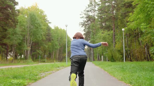 Teenager Boy Skateboarding on Skateboard in Summer City Park Track Shot