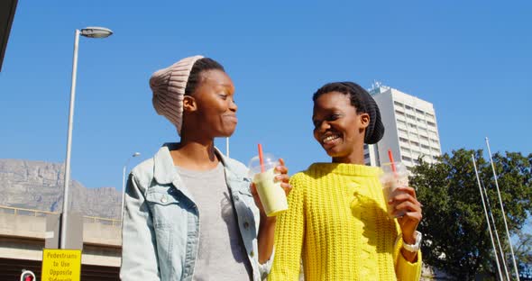 Twin sisters walking together in the city 4k