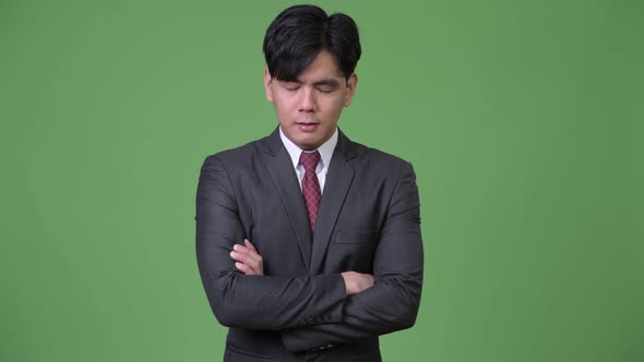 Young Angry Asian Businessman with Eyes Closed and Arms Crossed