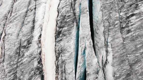 A Fascinating Aerial View of the Deep Cracks of the Glacier and the Lava Fields of a Large Volcano