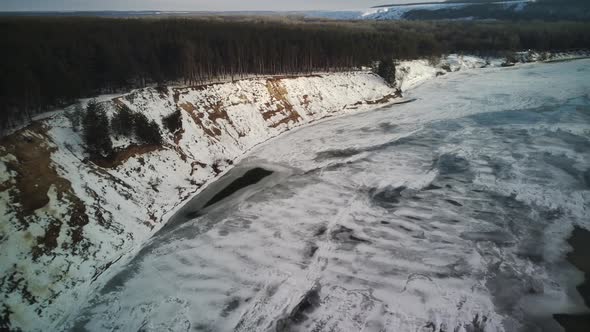 Calm Frozen River Covered with Ice on Cold Winter Day