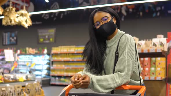 Girl in a Mask Has Shopping in the Supermarket