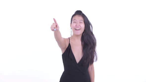 Happy Beautiful Asian Woman Pointing Finger and Ready To Party