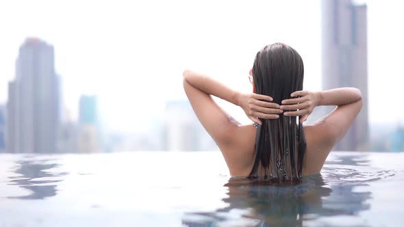 Young asian woman enjoy around outdoor swimming pool for leisure