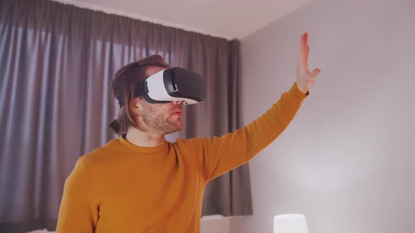 Young Man with VR Headset Experiencing Virtual Reality