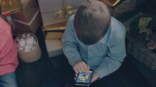 Little Boy in Blue Shirt Plays Mobile Games on Smartphone