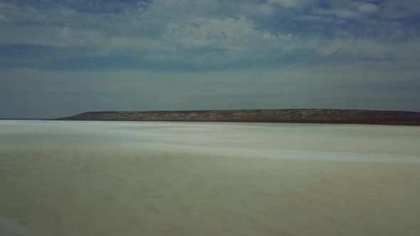 Road in the Steppes of Kazakhstan Muddy River. View on Very Long Road Till Horizon. 