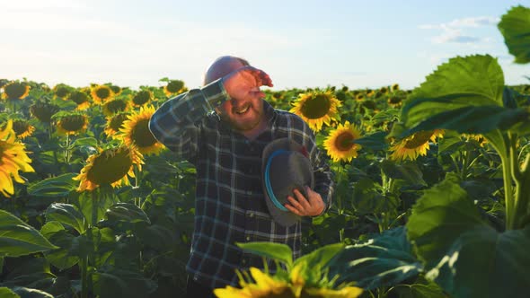 Exhausted Senior Farmer in Checkered Shirt Touching Forehead While Looking at Camera