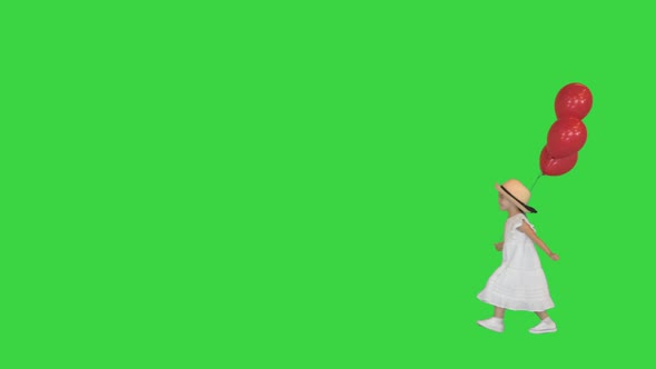 Little Girl Walking By with Red Balloons on a Green Screen Chroma Key