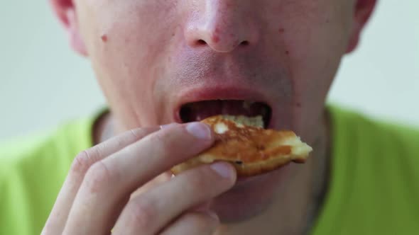Close up man eats with great pleasure, man eats pancakes, food. Bad food.
