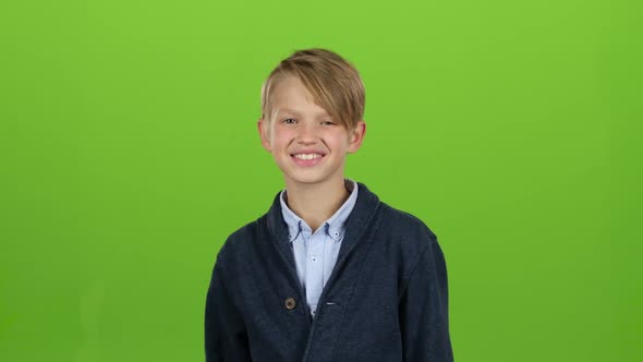 Child Shows Thumbs Up. Green Screen