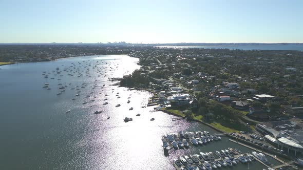 Sunrise aerial view of Sydney Harbour neighborhood over boats marina with city cbd skyline in the ho