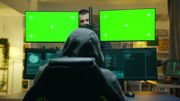 Team of Hackers Using Computer with Green Screen Mockup