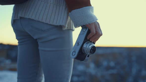 Female hand with a retro camera