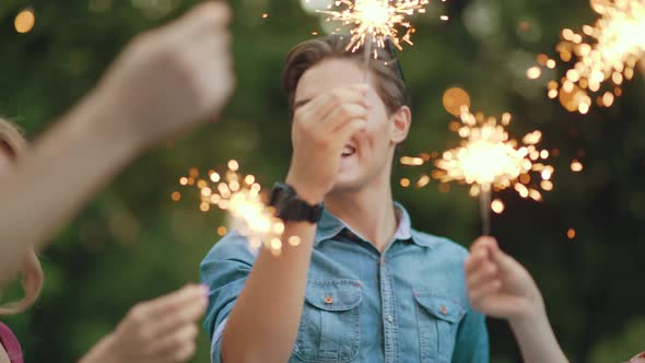 Happy Friends With Sparklers Having Fun Outdoors