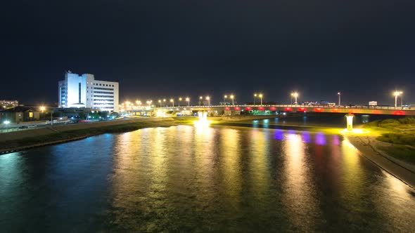 Modern Houses and Illuminated Bridge on the Riverside Ural in City Atyrau Timelapse Hyperlapse