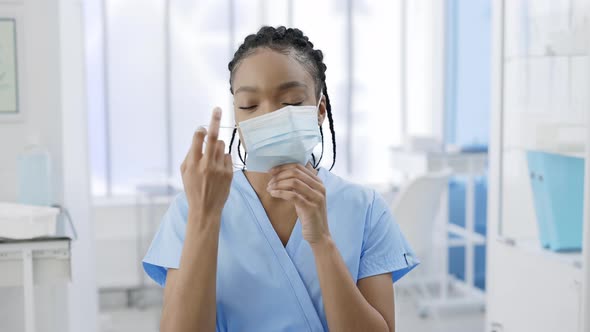 Crop View of Afro  American Positive Woman Taking Off Medical Protective Mask and Looking to Camera