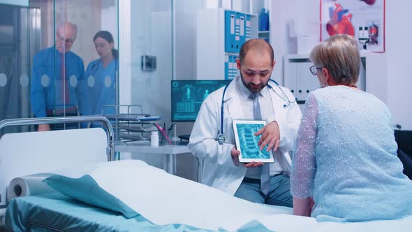 Doctor Presenting X Ray Scan on Digital Tablet