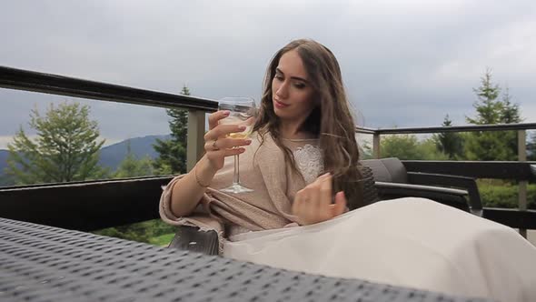 the Girl Drinks White Wine Sexy Young Woman with Glass of Wine