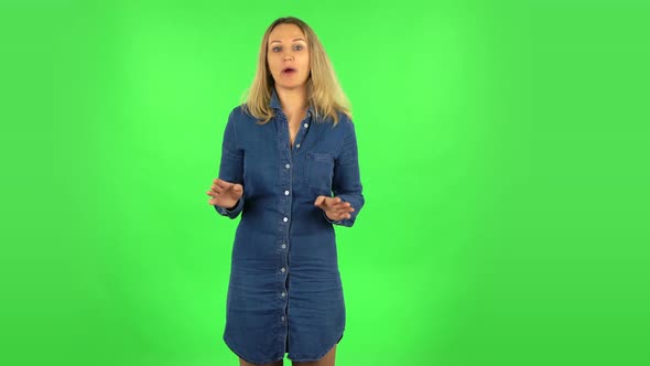 Fair Woman Is Reporting and Telling a Lot of Interesting Information. Green Screen