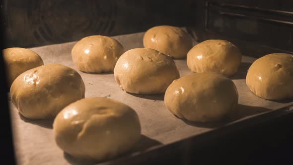 Motion Timelapse Of Delicious Glazed Buns Baking In A Pre-heated Bakery Oven - close up