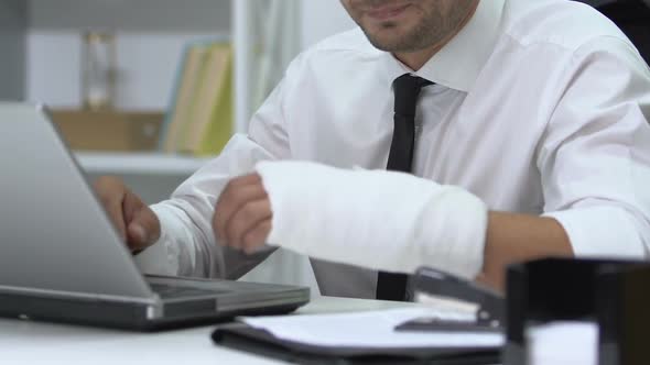 Male Manager Holding Injured Wrist, Working After Trauma Without Free Days