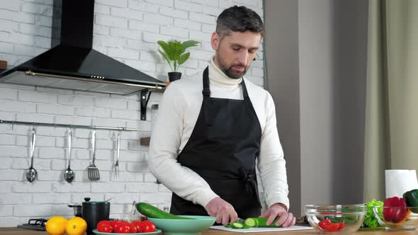 Man chef listens tells teaches housewife online video call, sliced cucumber