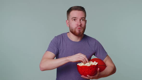 Bearded Young Man Basketball Fan Eating Popcorn Doing Winner Gesture Celebrating Victory Win