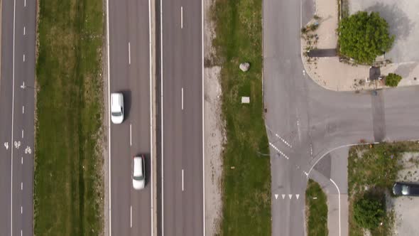 Busy road of Vällingby suburb in Stockholm, Sweden. Aerial tilt down forward