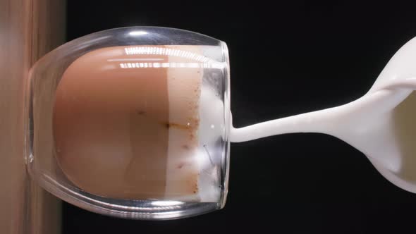 Cappuccinos Delicious Aromatic Coffee Drink Pours Milk Foam From a Milk Jug in a Transparent Glass