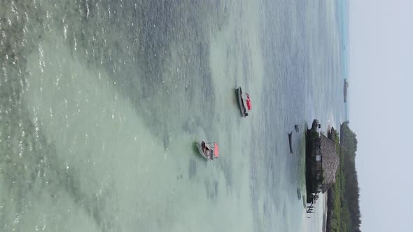 Vertical Video House on Stilts in the Ocean on the Coast of Zanzibar Tanzania Aerial View