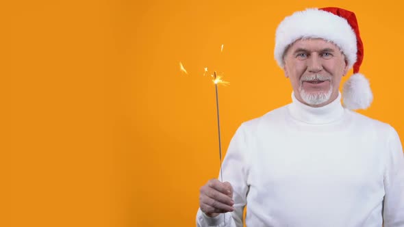 Male Pensioner Santa Hat and Bengal Light Orange Background, Christmas Greeting