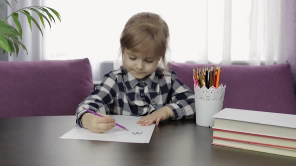 Cute Child Girl Studying Drawing Picture with Pencil at Home. Distance Education