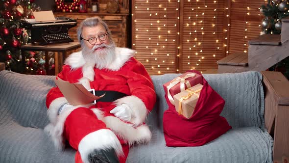 Happy Santa Claus Blogger Reading Christmas Gift Wish List