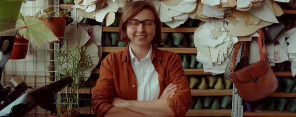 Portrait of Happy Female Shoemaker in Workshop