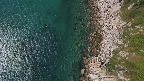 Aerial Shot of Mountain Cliff and Blue Sea Water