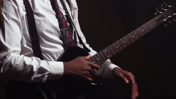 Happy Smiling African American Young Man in Stylish Suit Plays Electric Guitar and Sings a Song