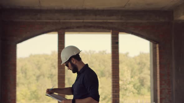 Civil Engineer Architect Construction Site.Builder Engineer Developer In Helmet Inspecting Building.