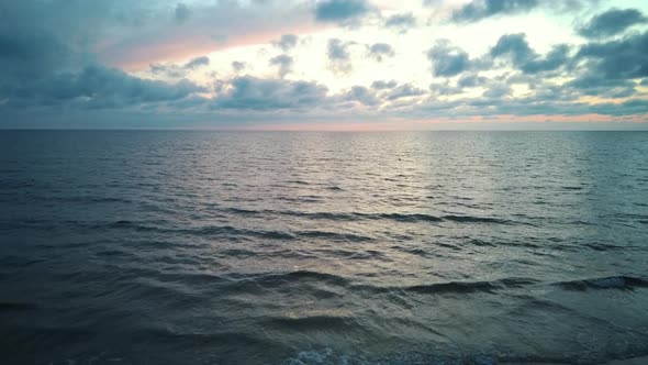 Dron Flying Over Sea in a Beautiful Sunset.  Sunrise Over the Sea. Colorful Sunset on the Baltic Sea